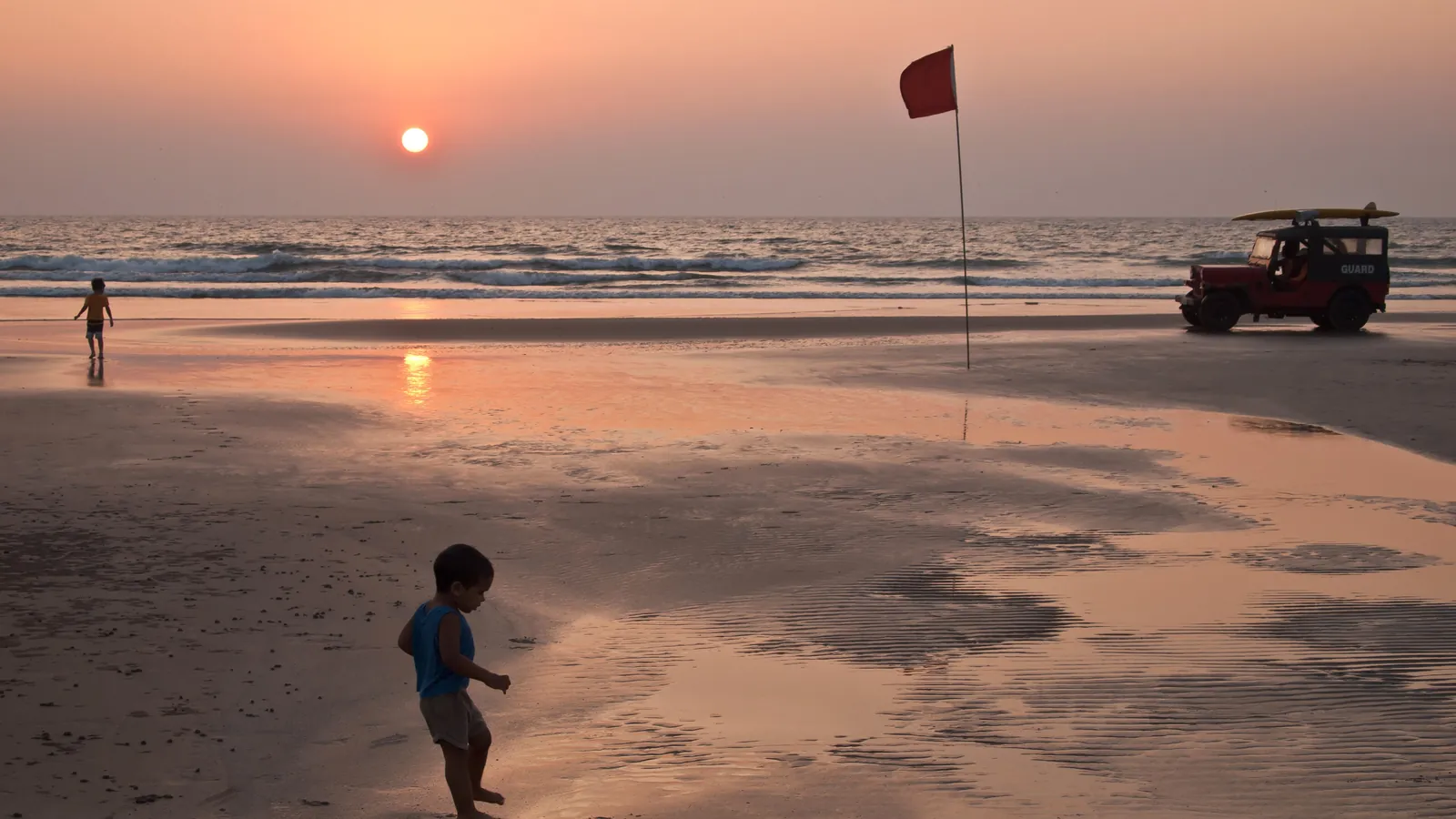 The sun sets over the sea at a beach in Goa