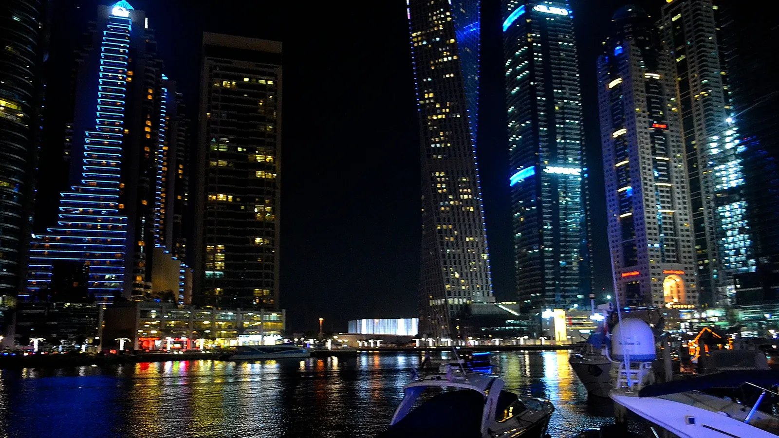 The glittering towers of Dubai Marina lit up at night along the waterfront