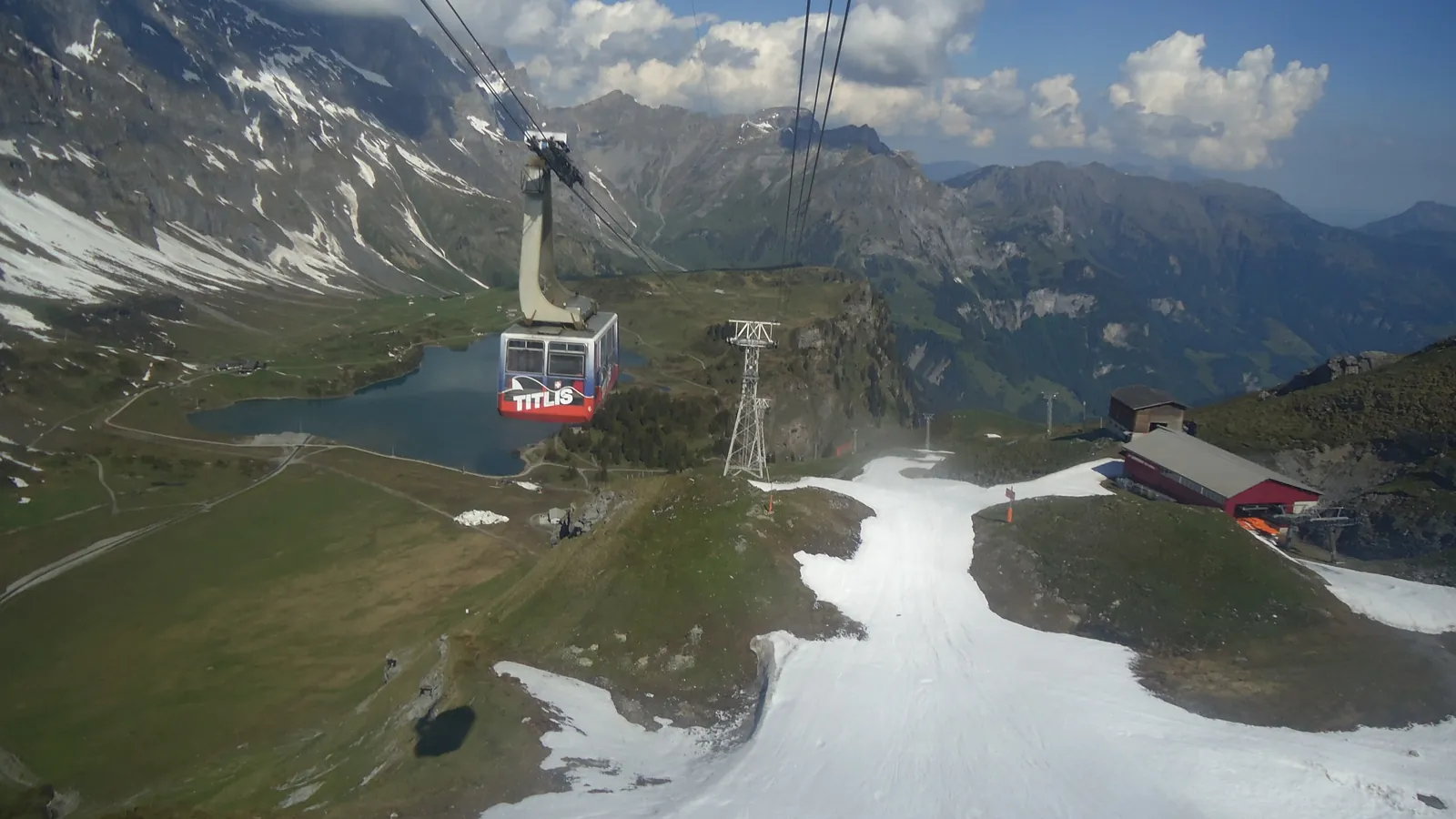 The Titlis cable car climbs over snowfields and alpine meadows above Engelberg in central Switzerland