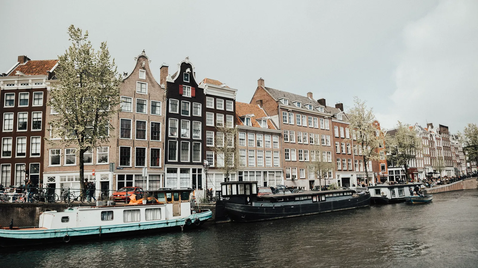 Tall, narrow canal houses line the water in Amsterdam, whose 17th-century canal ring is a UNESCO World Heritage Site