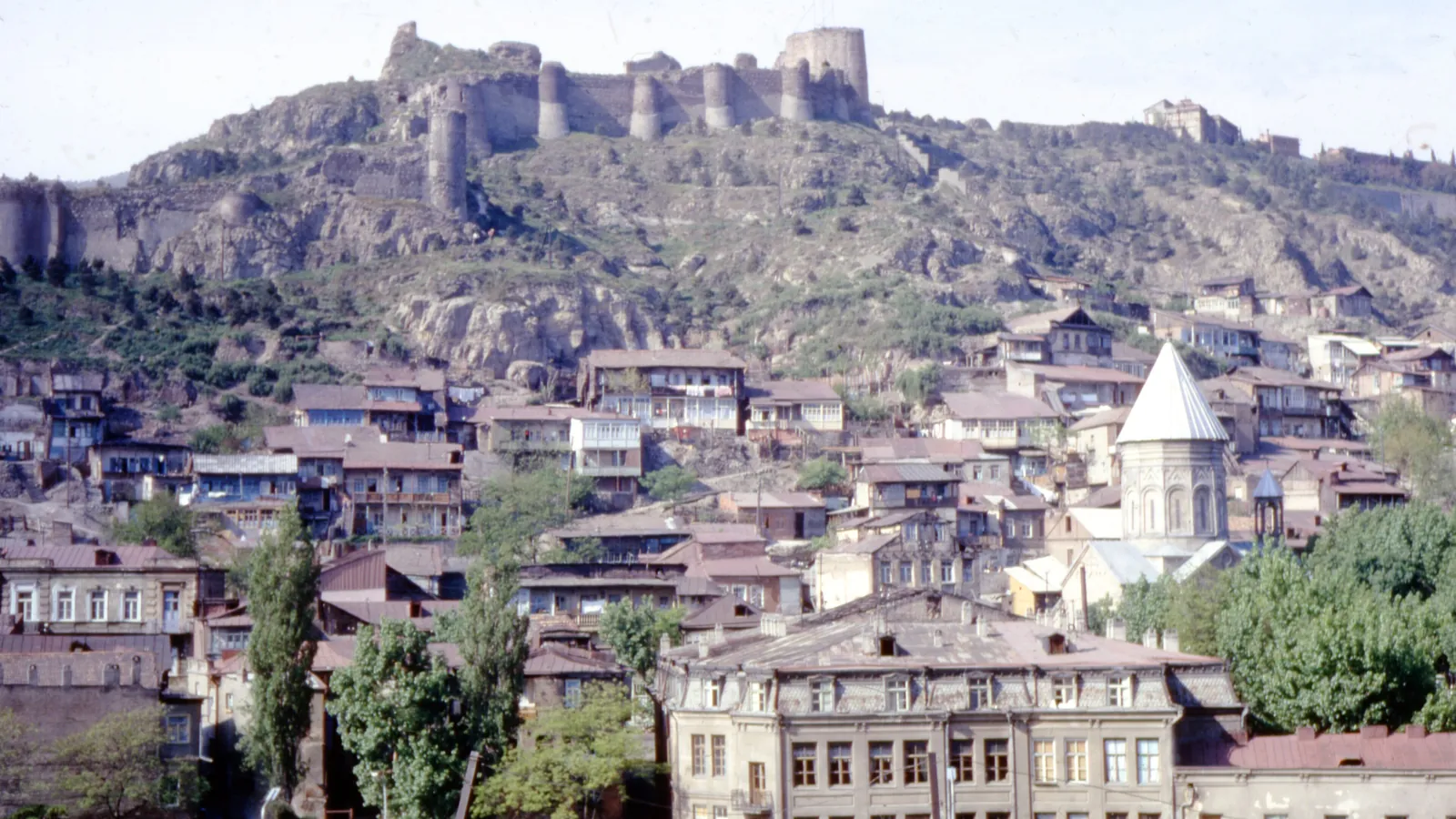 The old town of Tbilisi beneath the ancient Narikala Fortress, with its churches and wooden balconies