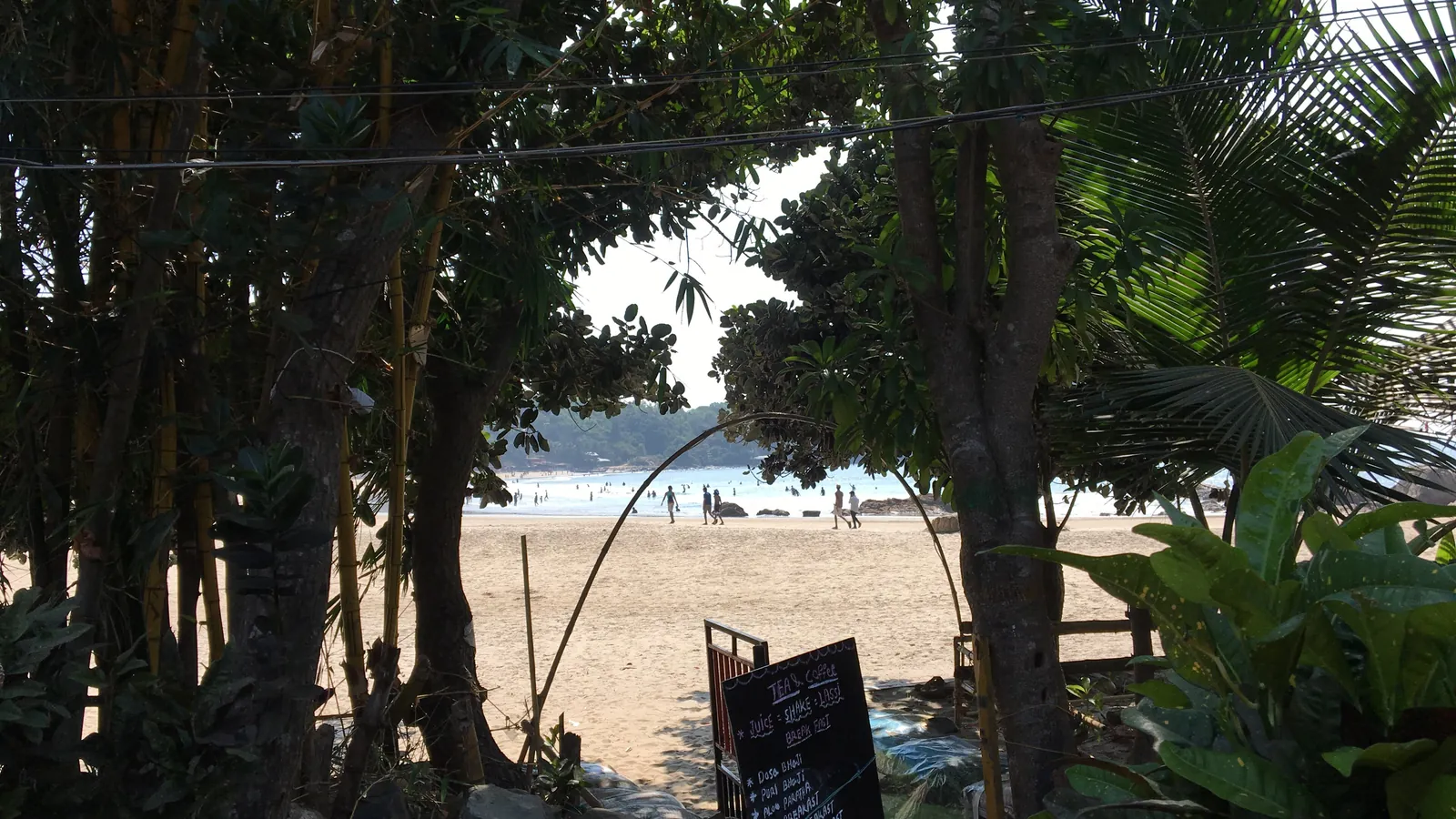 Kudle Beach seen through the trees on the cliff path in Gokarna