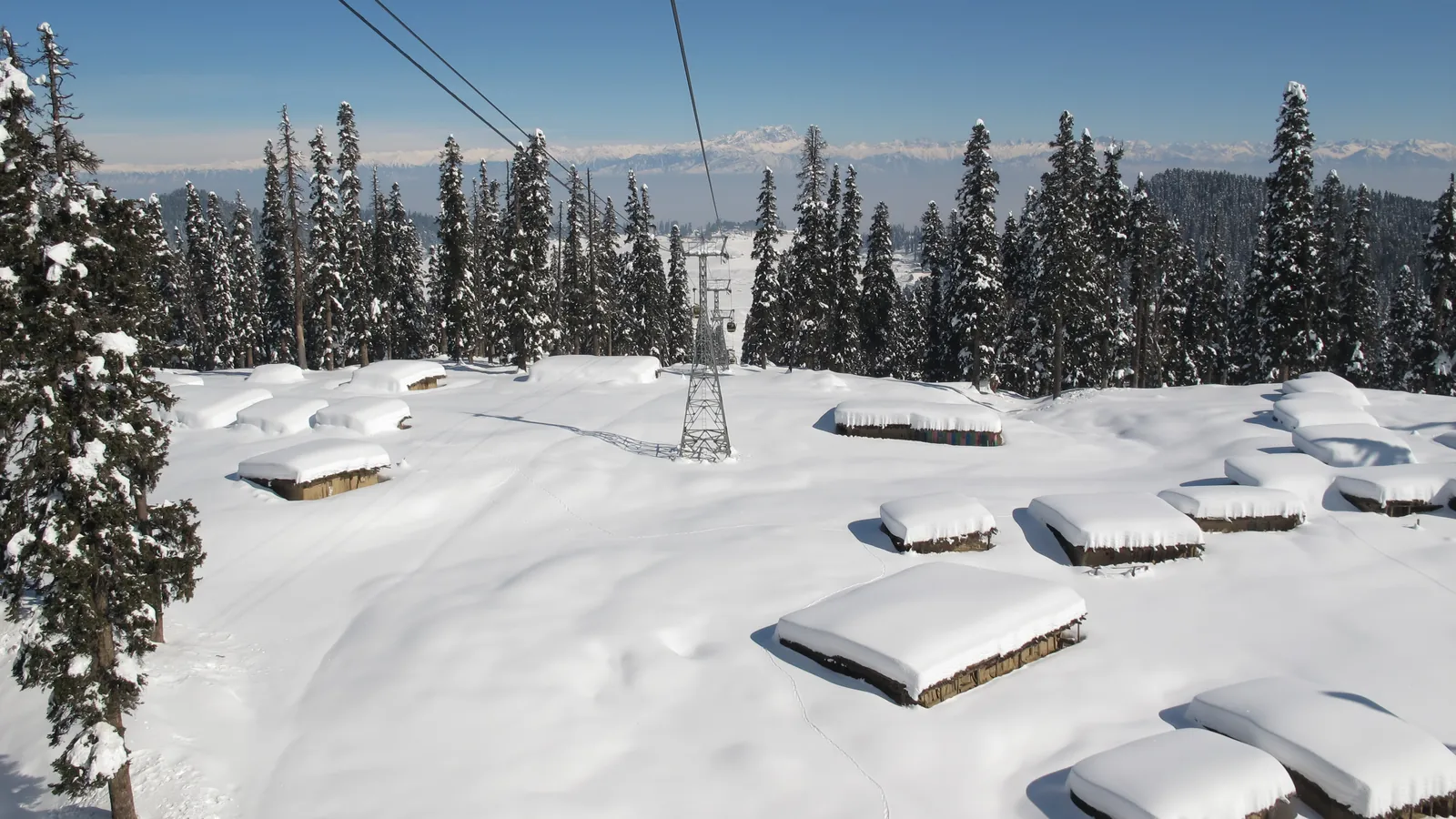 The Gulmarg Gondola cable car rises over the snowy slopes towards Mount Apharwat