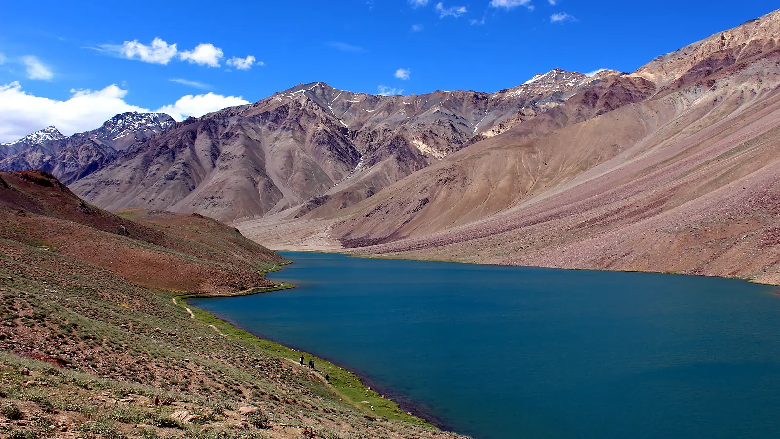 Chandratal in July, when the snow has melted and the lake's colour shifts from turquoise to deep blue