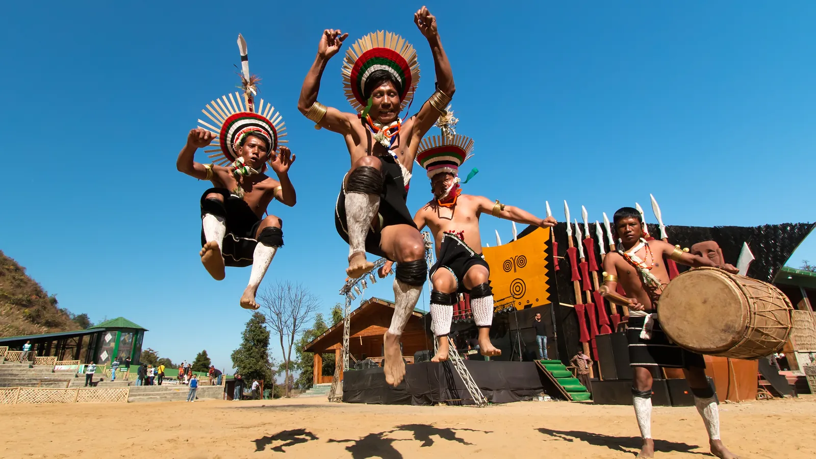 Naga performers in traditional headdresses leap during a dance at the Hornbill Festival