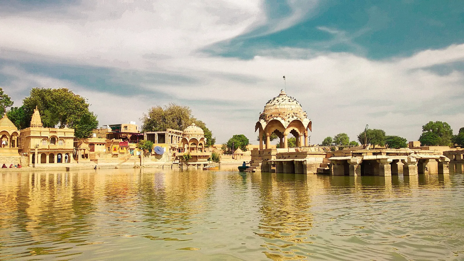 Temples and chhatris reflected in the water of Gadisar Lake in Jaisalmer