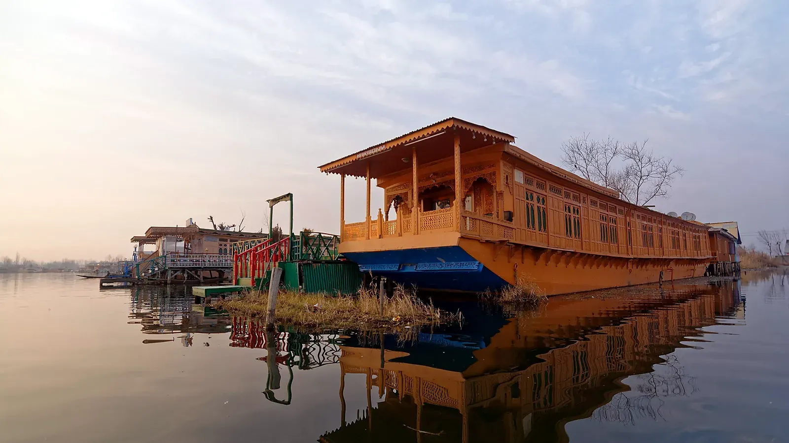 Traditional cedar houseboats moored along Dal Lake in Srinagar, where staying on the water is part of the Kashmir experience