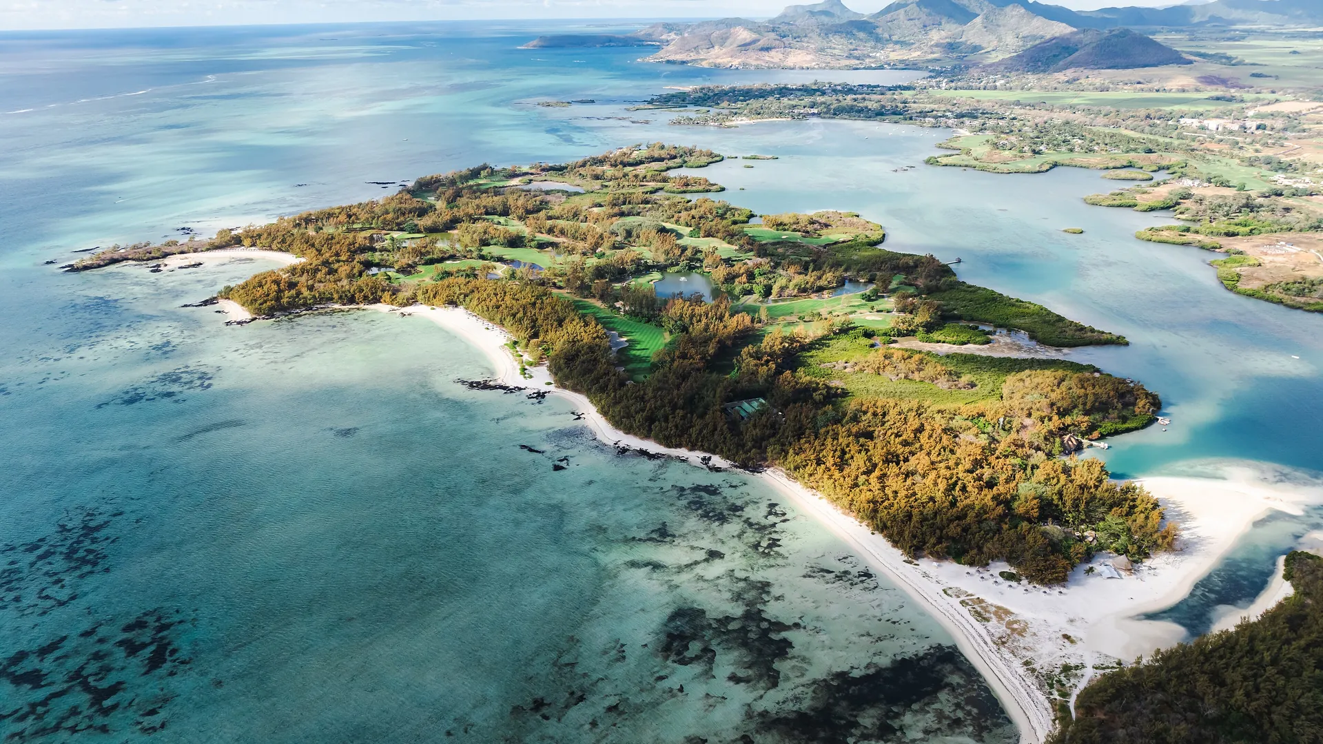 Aerial view of รle aux Cerfs and the turquoise lagoon on the east coast of Mauritius