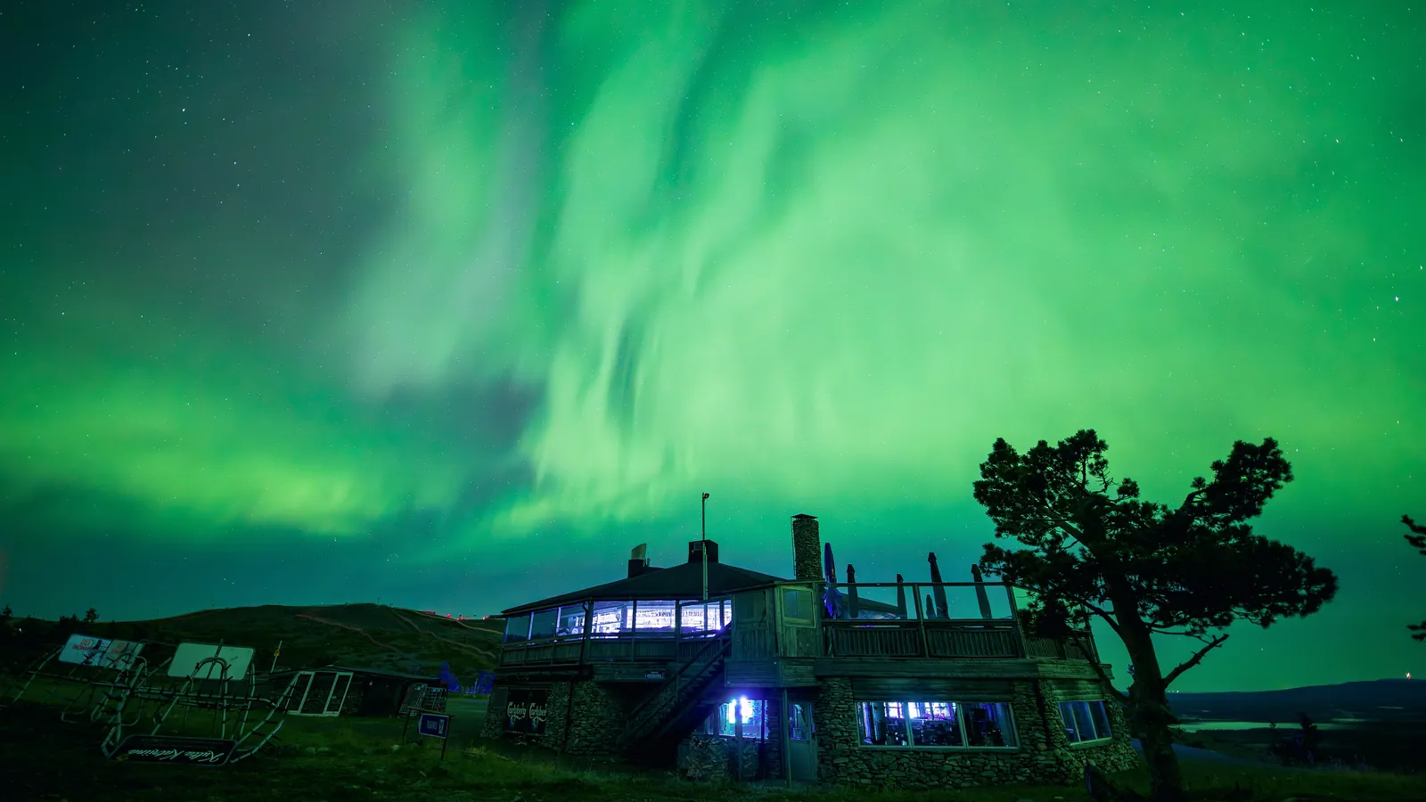 The northern lights shine over snow-covered Lapland in northern Finland