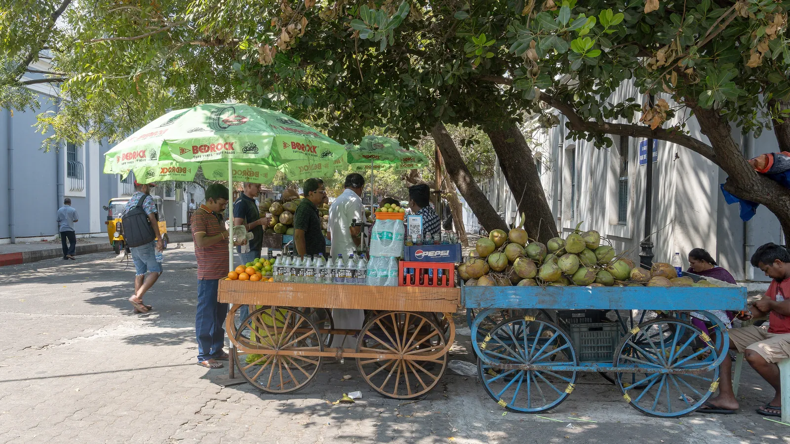 A fruit and coconut cart on a street in Pondicherry's French Quarter