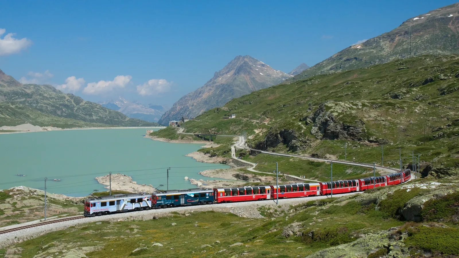 The Bernina Express runs beside Lago Bianco near the Bernina Pass, the highest point of the line across the Alps