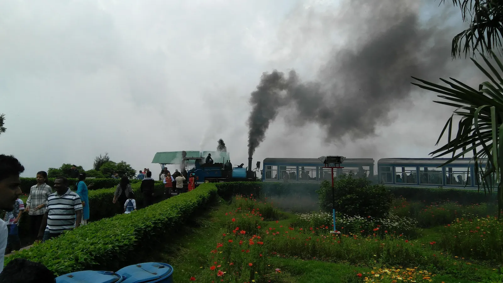 A Darjeeling Himalayan Railway toy train steams around the Batasia Loop, a spiral of track in the hills below Darjeeling