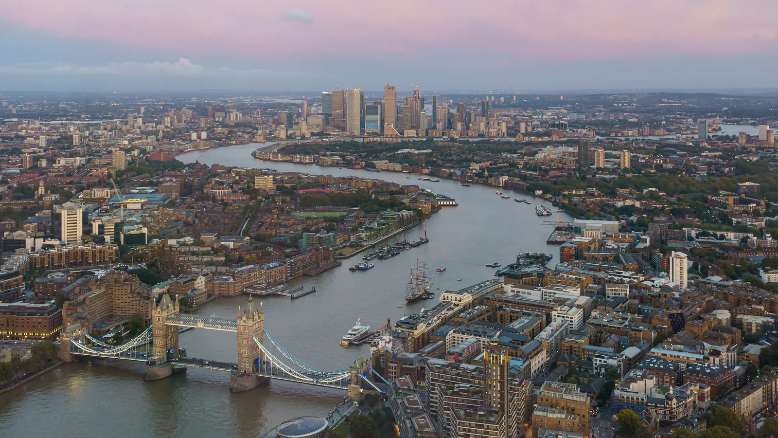 Tower Bridge and the curve of the Thames through London, seen from the Shard on an autumn evening