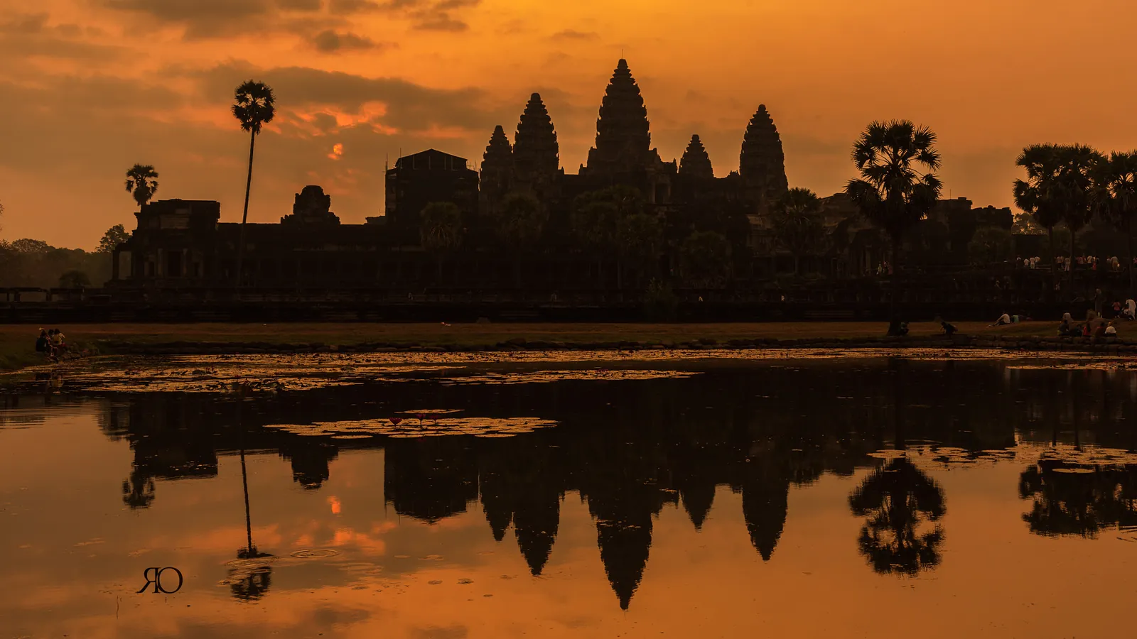 The silhouette of Angkor Wat reflected in a pool at sunrise in Cambodia