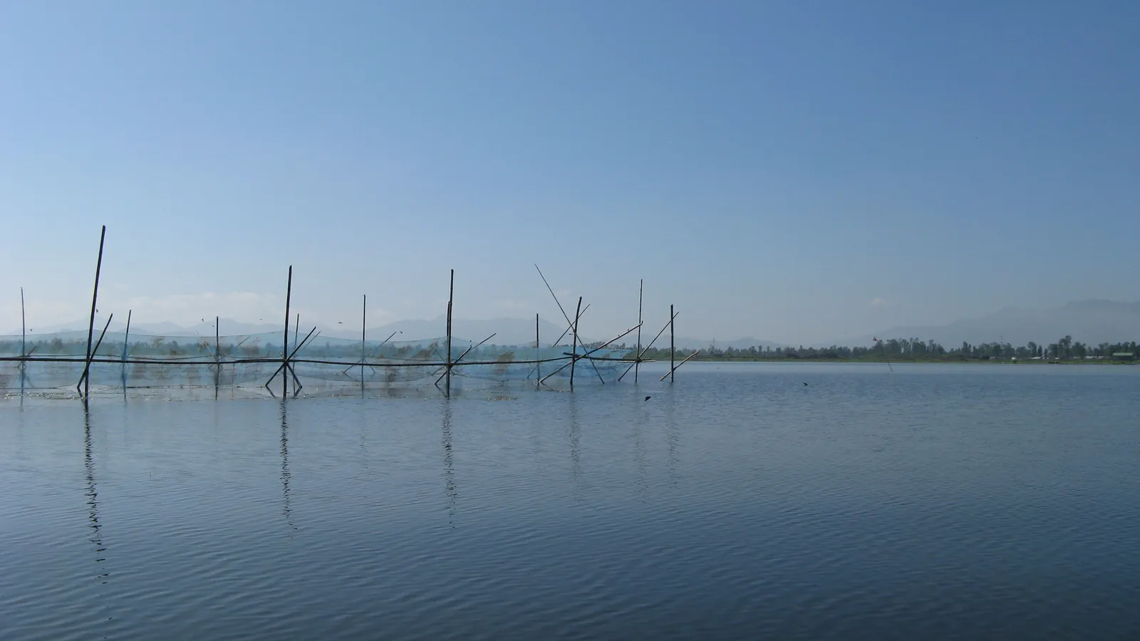 Mist lies over Loktak Lake in Manipur, famous for its floating islands of vegetation called phumdis