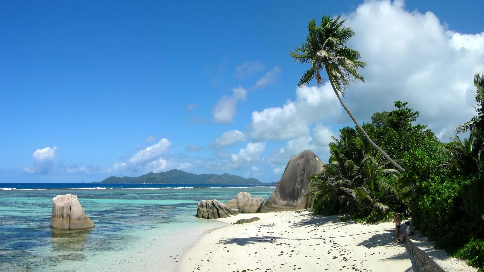 Granite boulders and palm trees on the beach at Anse Source d'Argent on La Digue in the Seychelles