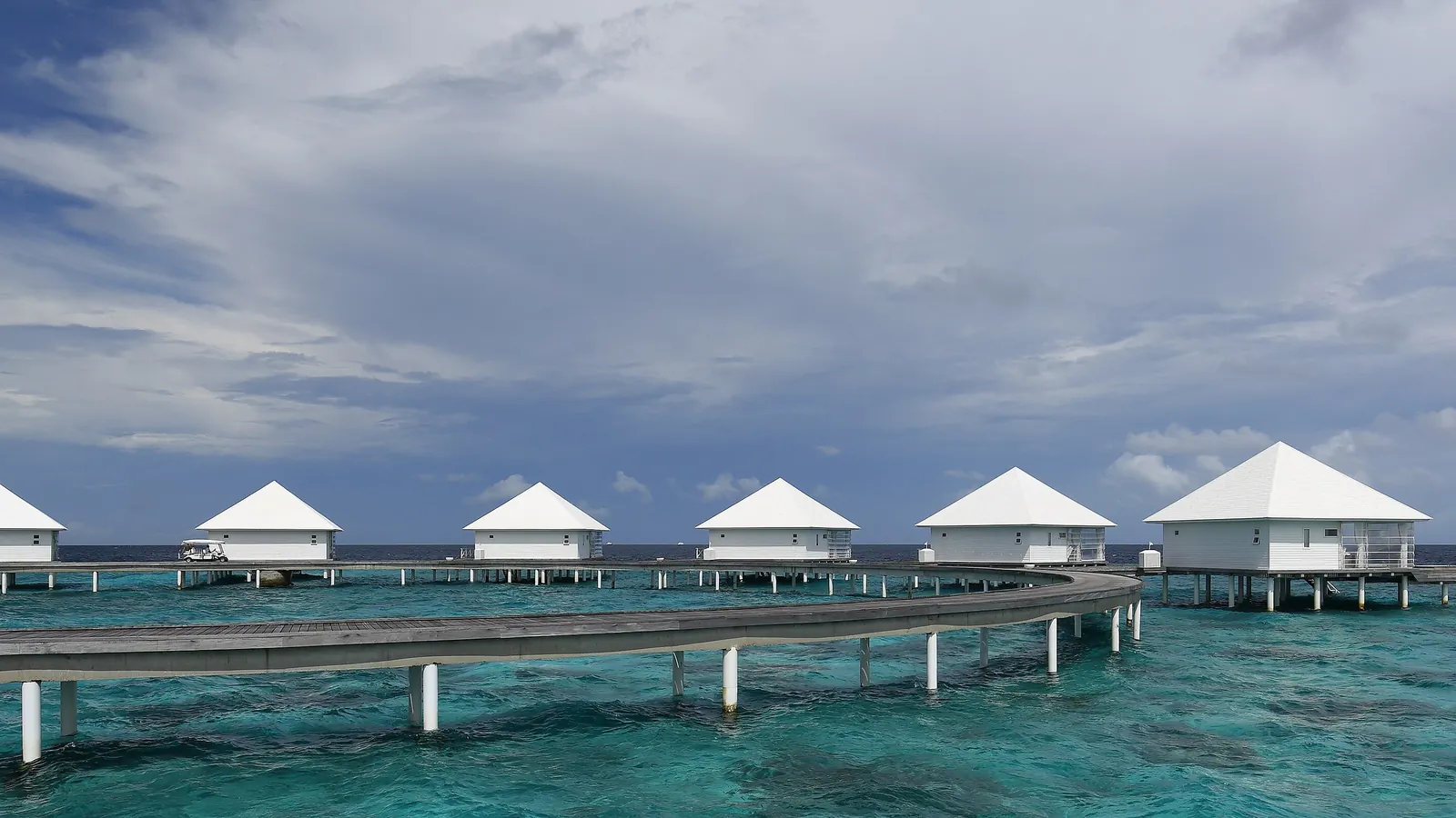 Overwater villas stand on stilts above a turquoise lagoon in the Maldives, where Indian tourists receive a free visa on arrival