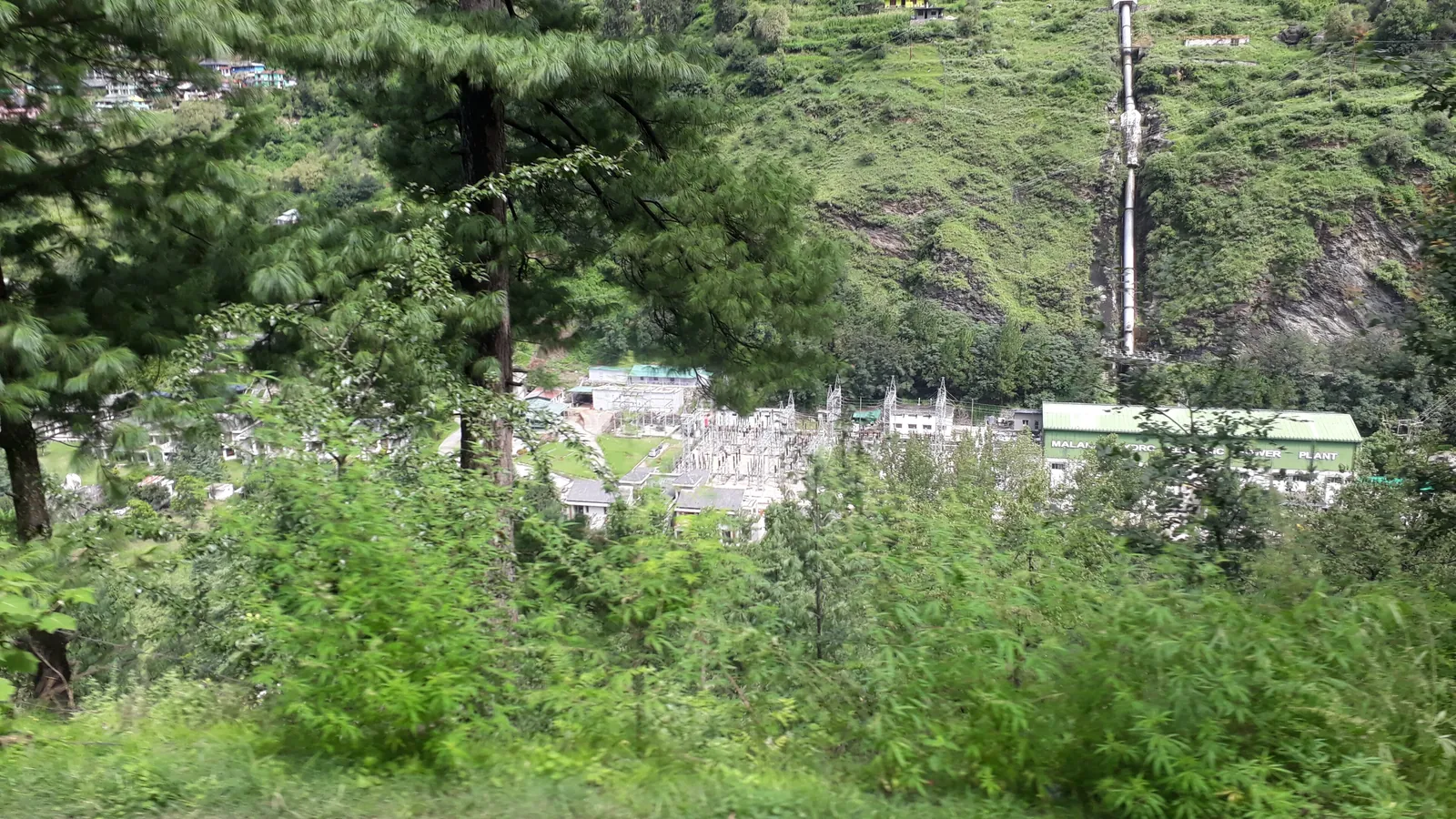 The Parvati River flowing through forested hills near Kasol in Himachal Pradesh